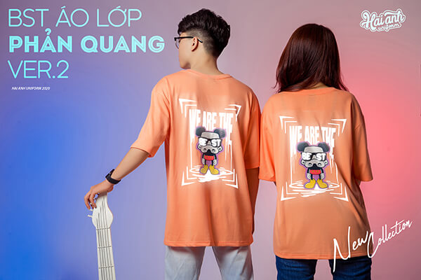 Mẫu áo lớp phản quang in decal màu cam coral với slogan “WE ARE THE BEST”